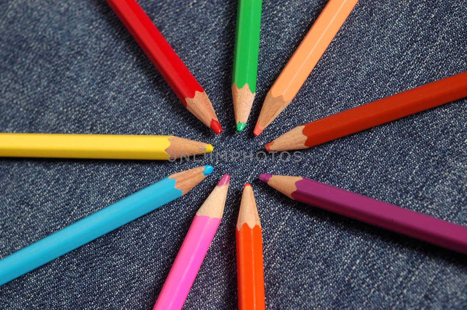 coloured crayons on a jeans background