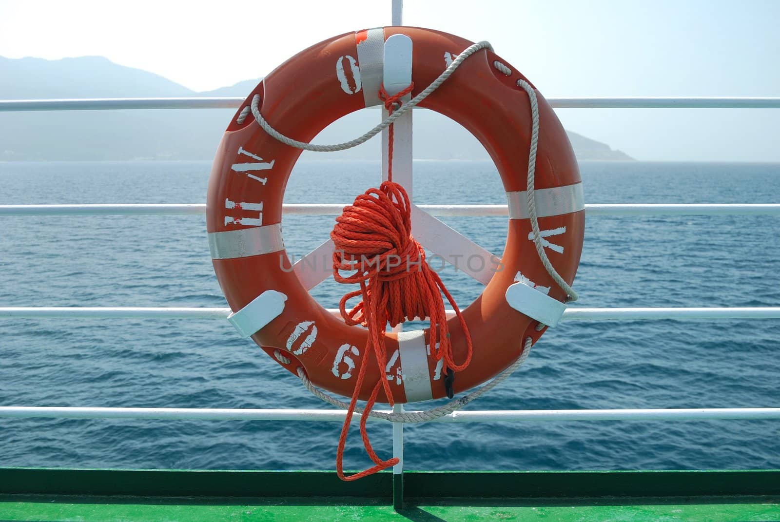 Red lifebelt on boat deck