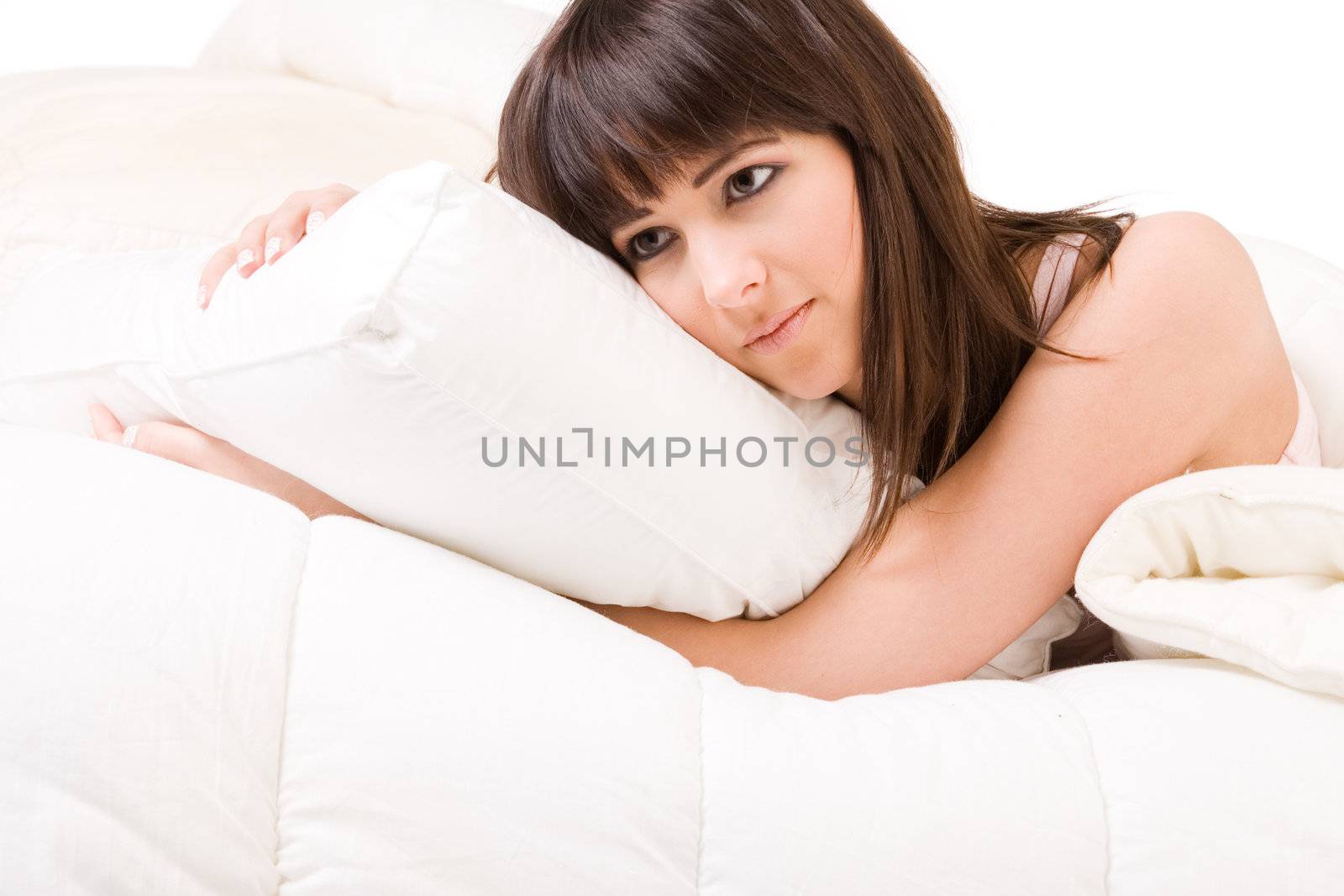 Cute girl in bed hugging her pillow