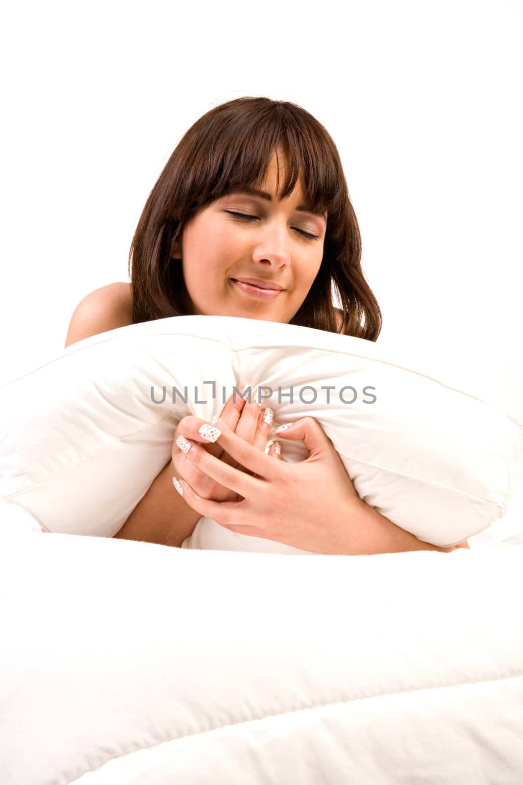 Cute girl in bed hugging her pillow