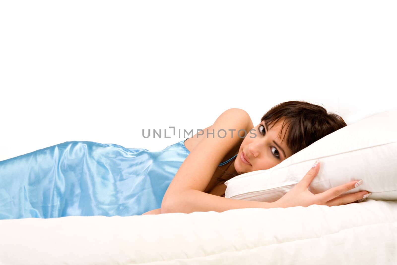 Cute girl in bed hugging her pillow