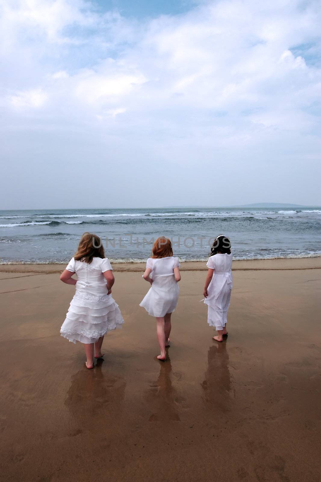 a picture of the time of the first communion and the joy thereafter of three friends going into the sea for a paddle