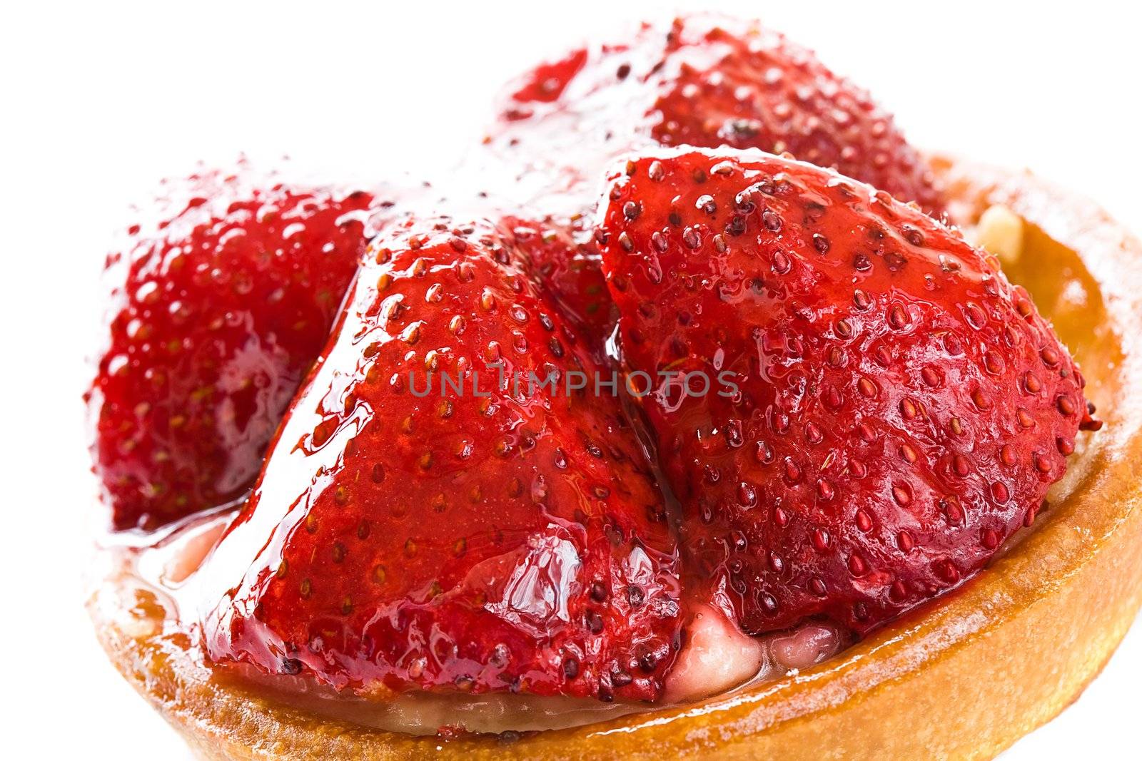 Round cake with parts of a strawberry close up on a white background 
