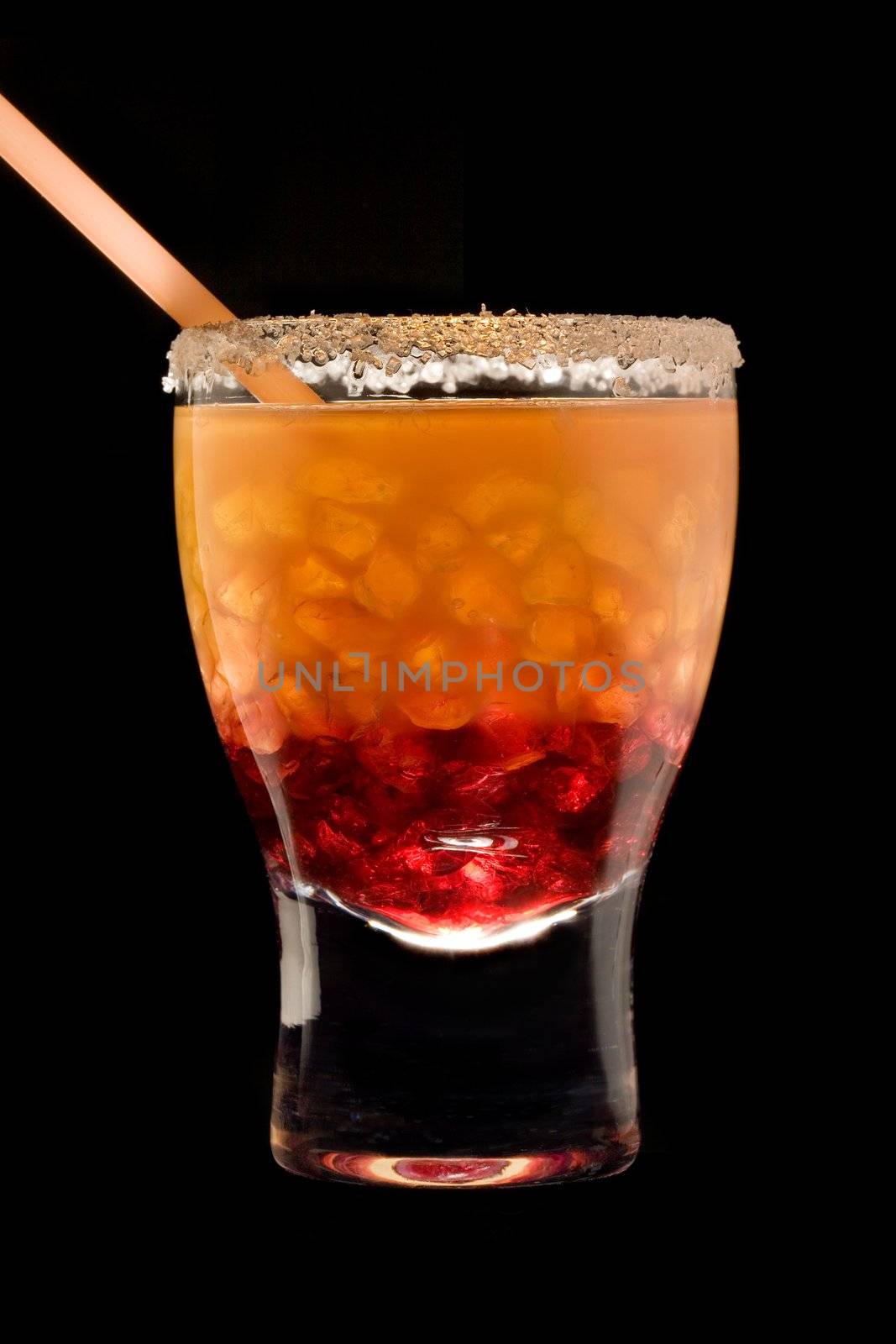 Cocktail in a glass with a tubule on a black background
