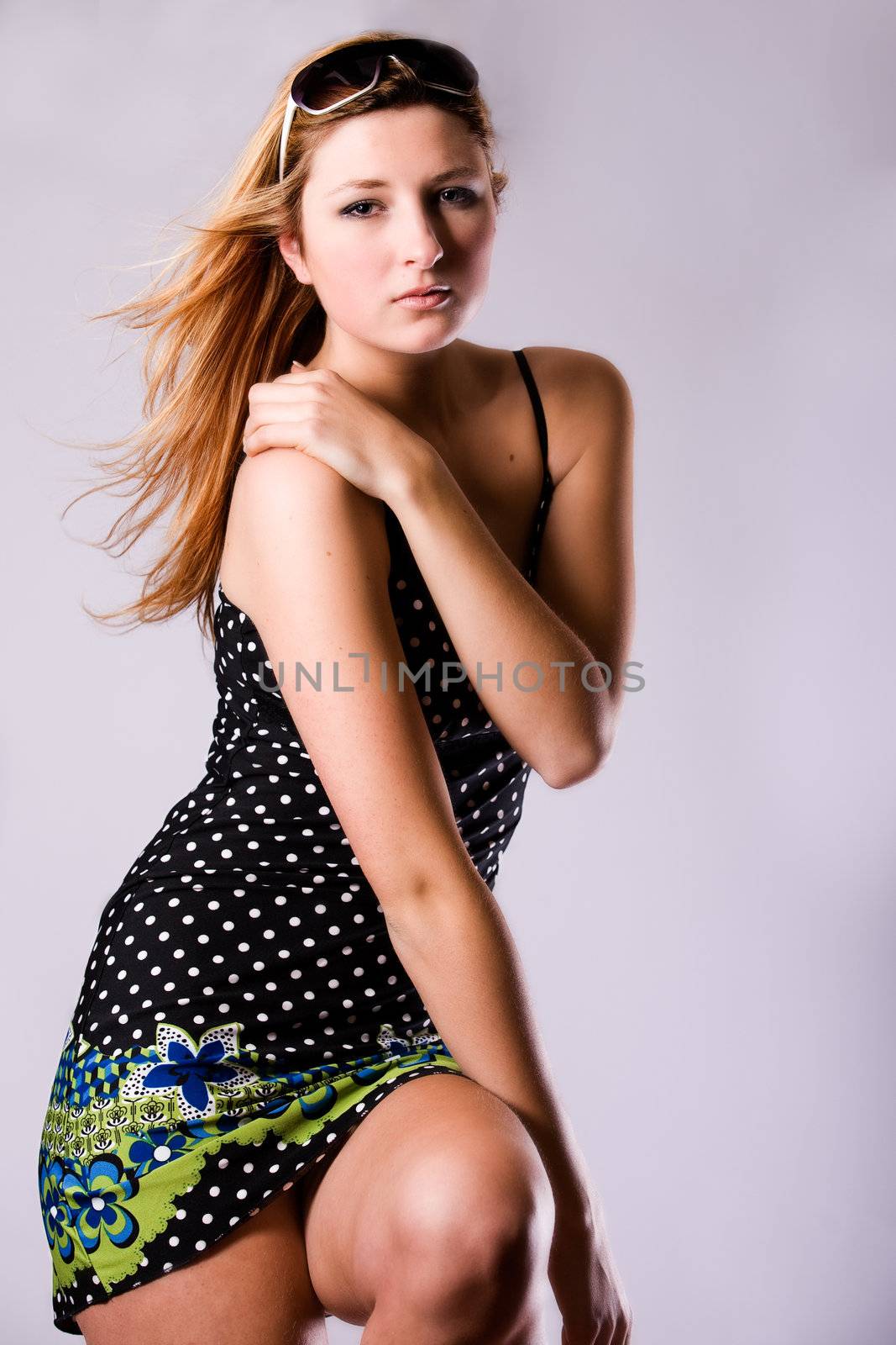 Beautiful girl with a pair off sunglasses in the studio