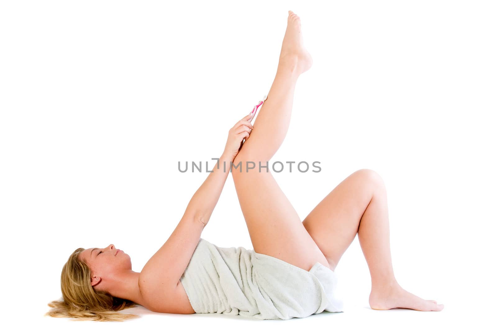 Studio portrait of a spa girl shaving her leg