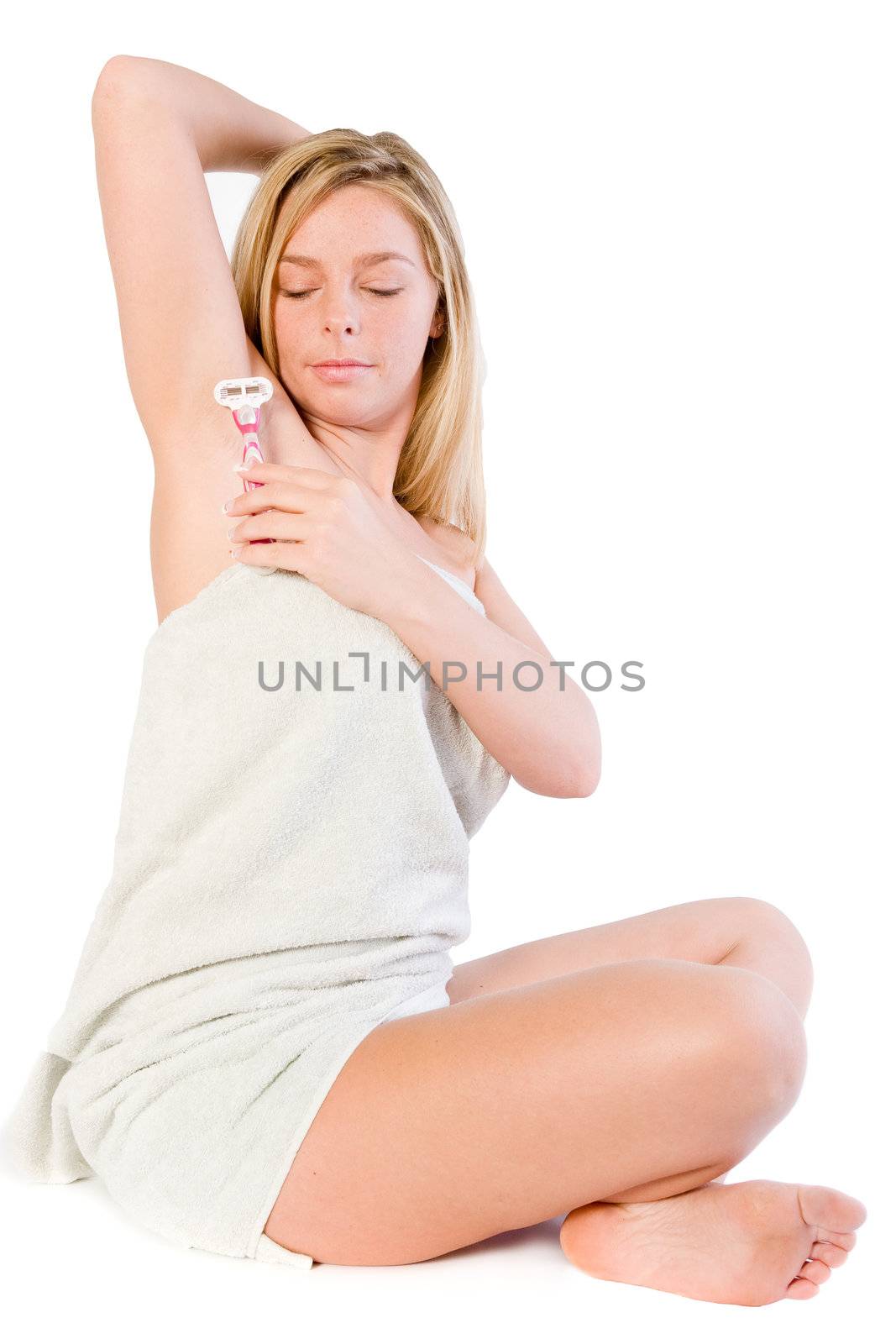 Studio portrait of a spa girl shaving her armpit