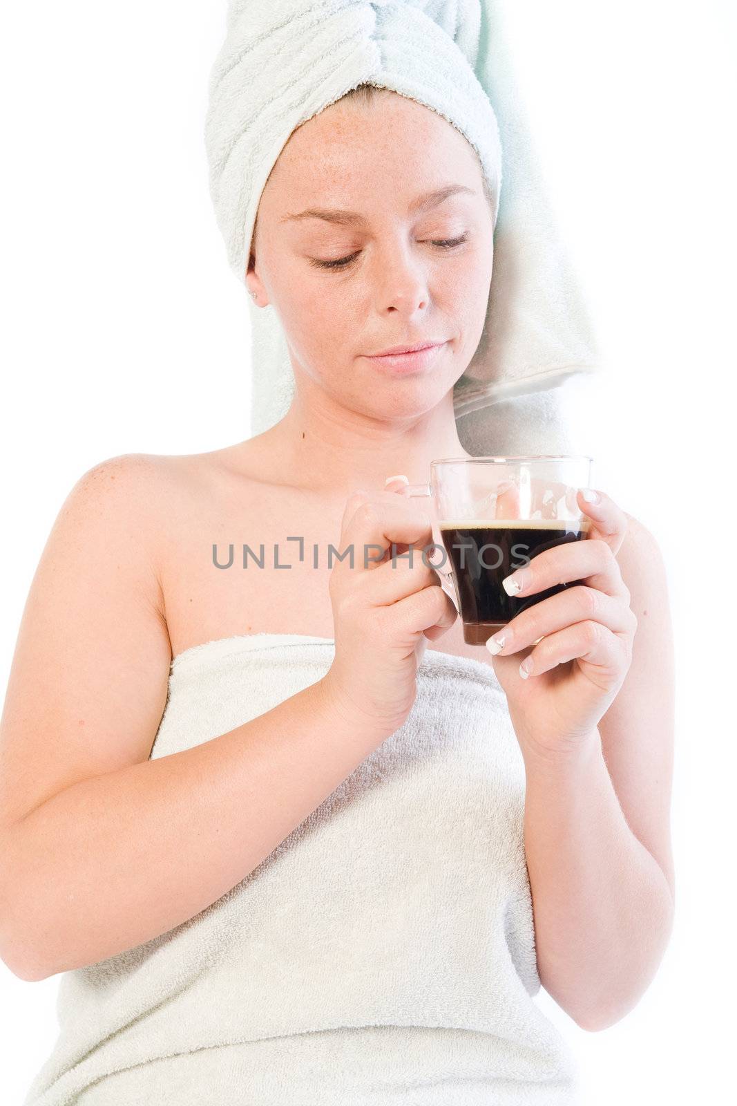 Studio portrait of a spa girl drinking coffee out of a glass