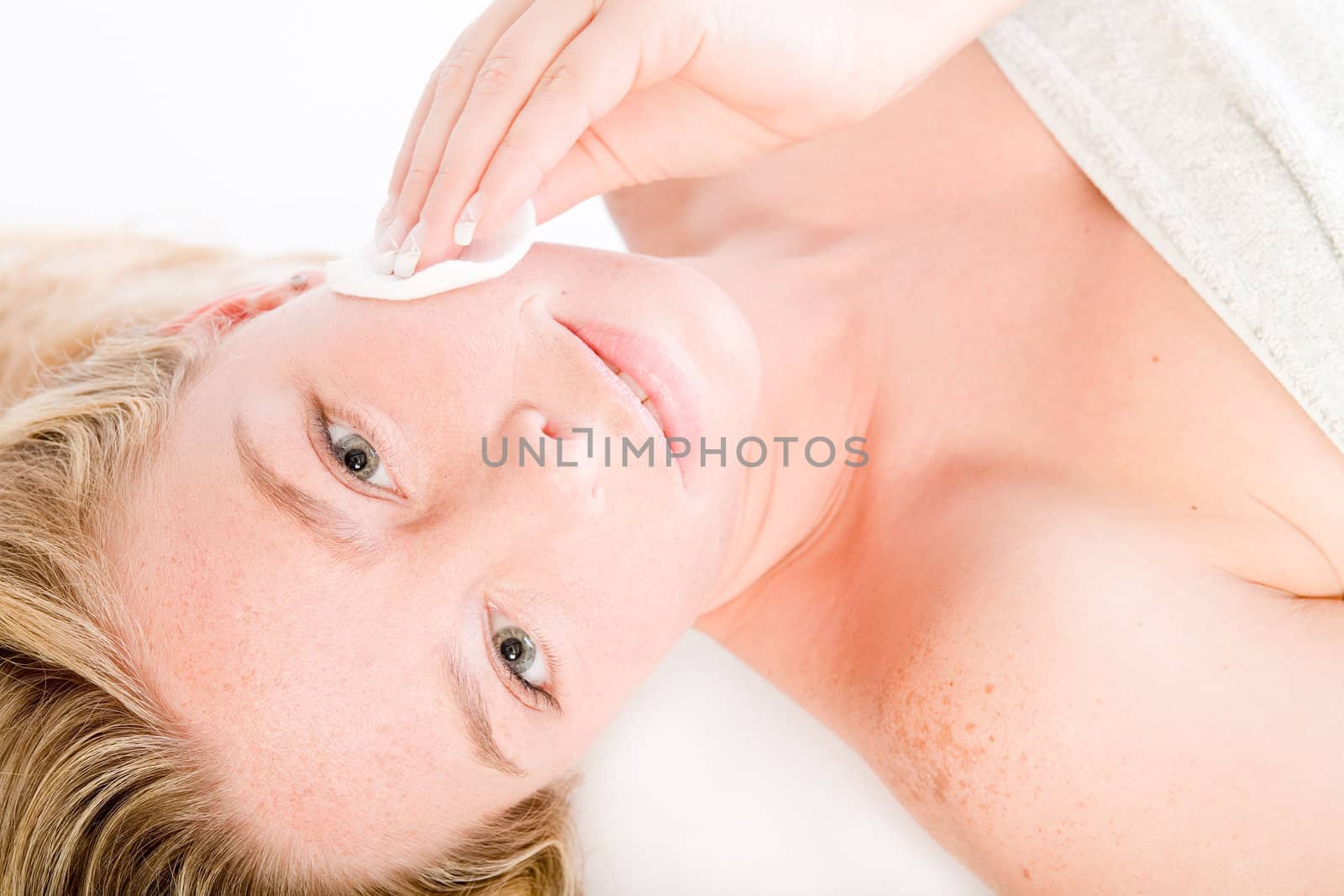 Studio portrait of a spa girl cleaning her face