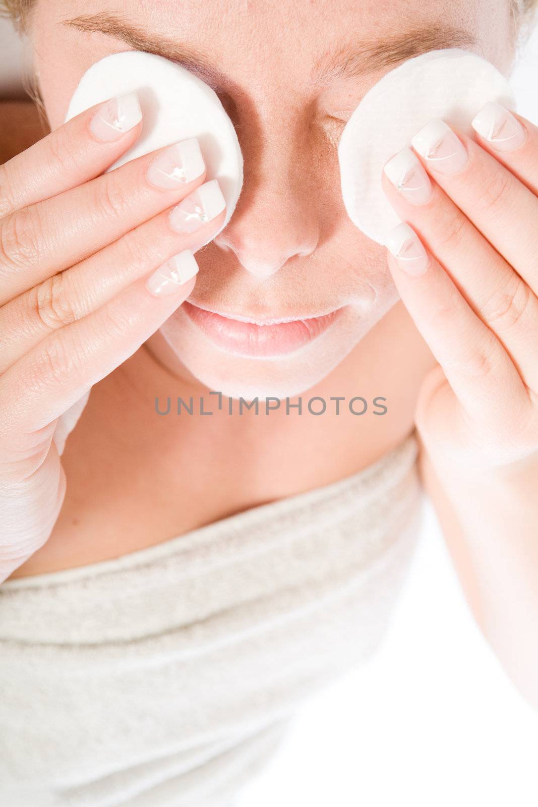 Studio portrait of a spa girl cleansing her eyes