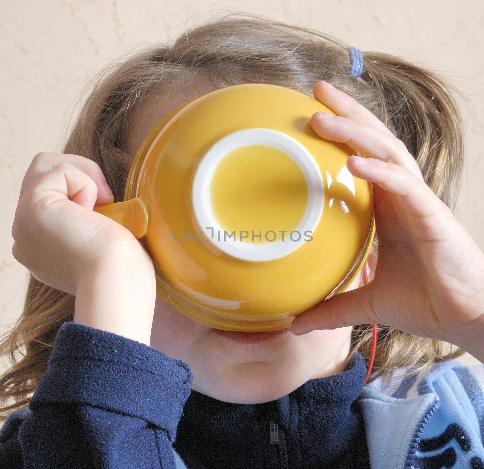 Girl drinking from bowl