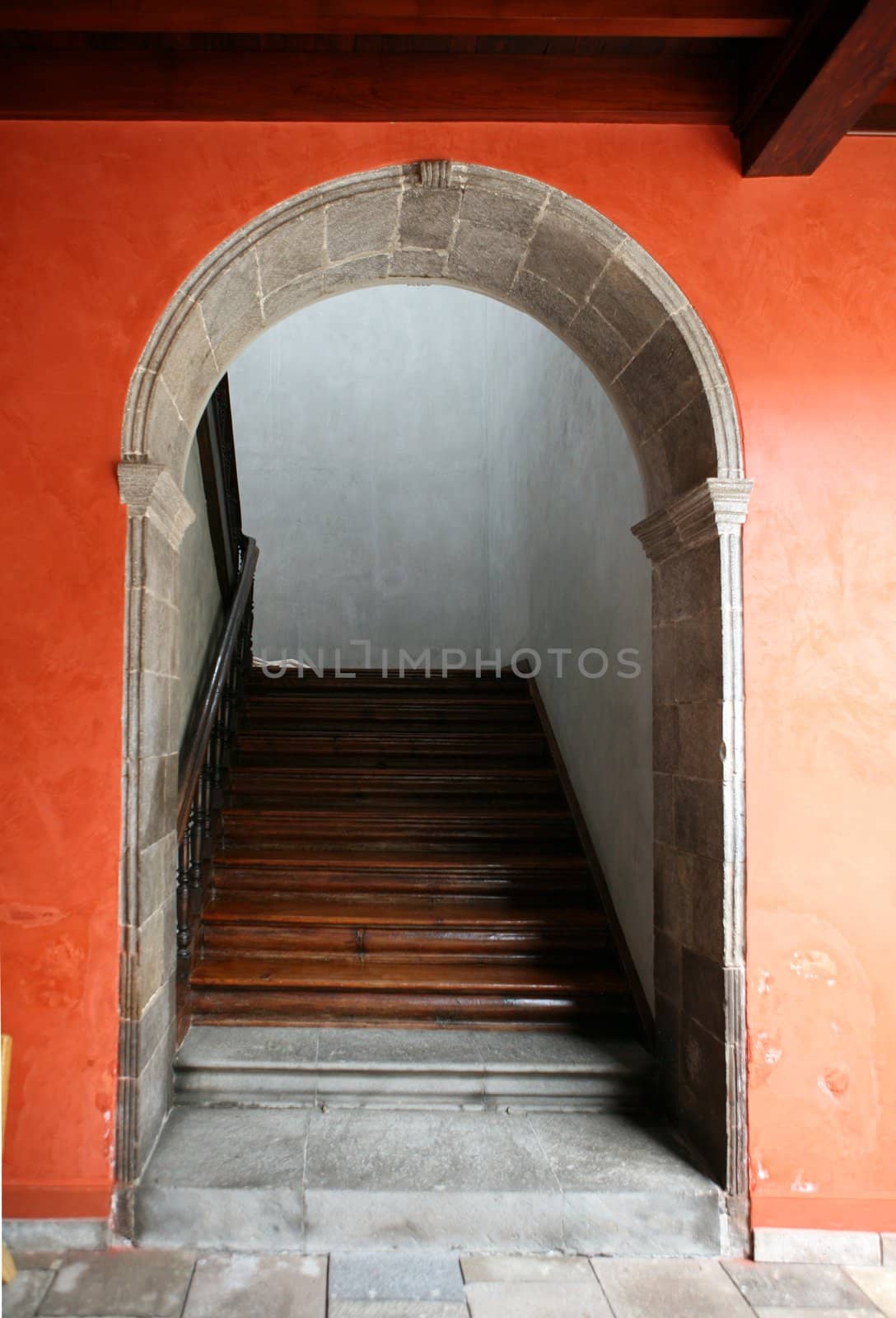 Arc entrance of house with wooden stairs