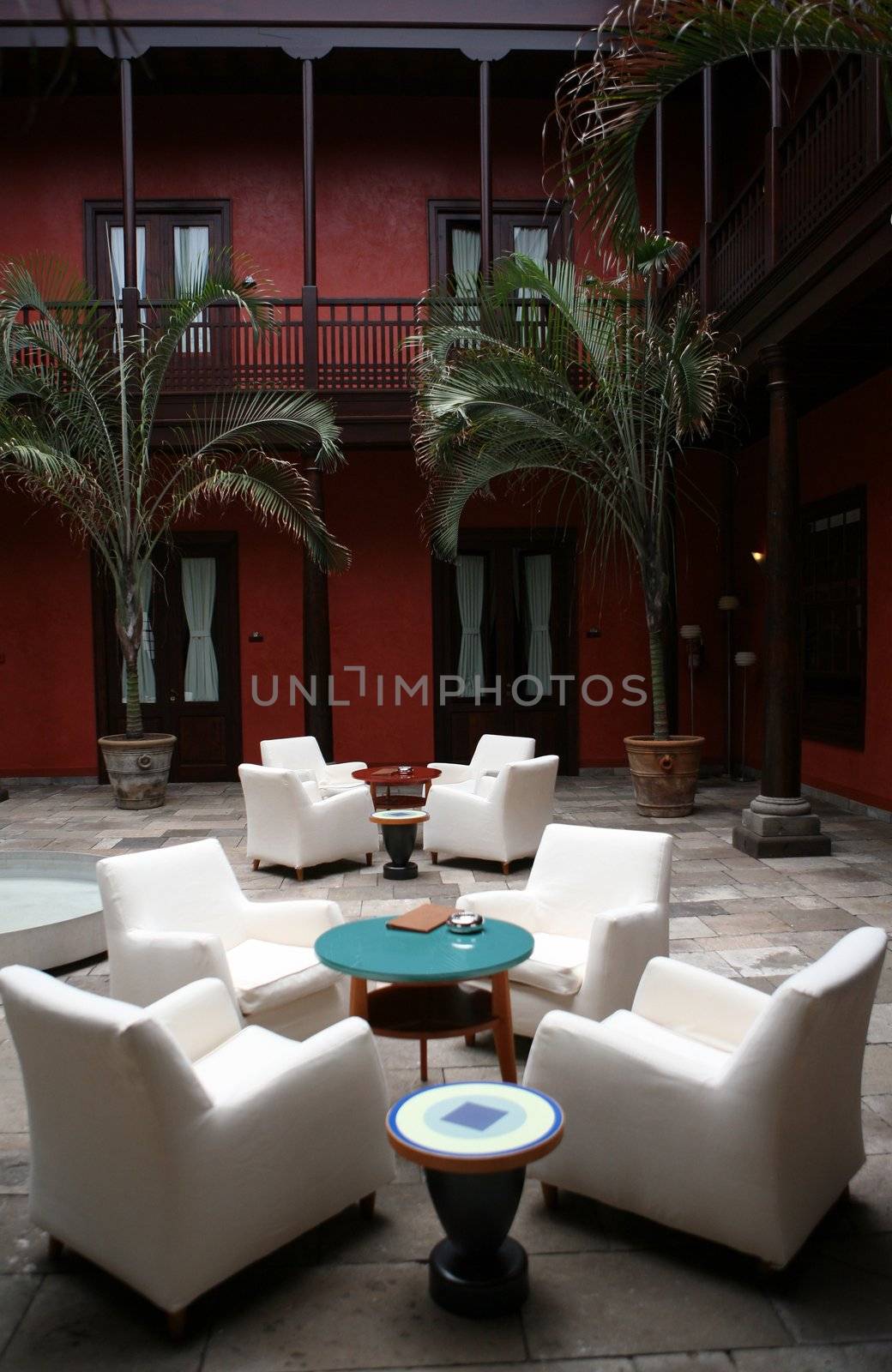 Cafe indoor with white sofas and blue glass small table