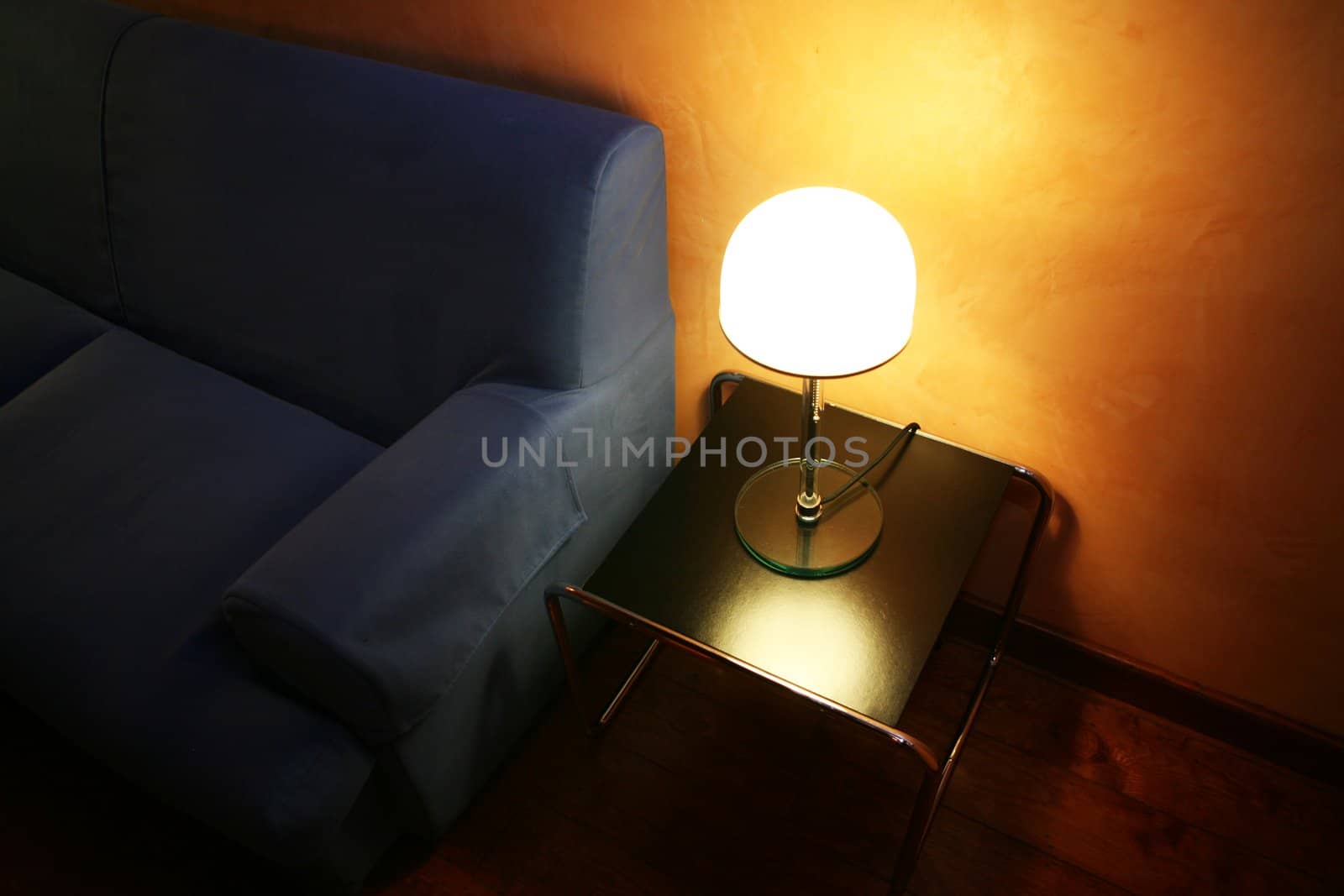 Blue sofa and smlal light in hotel room