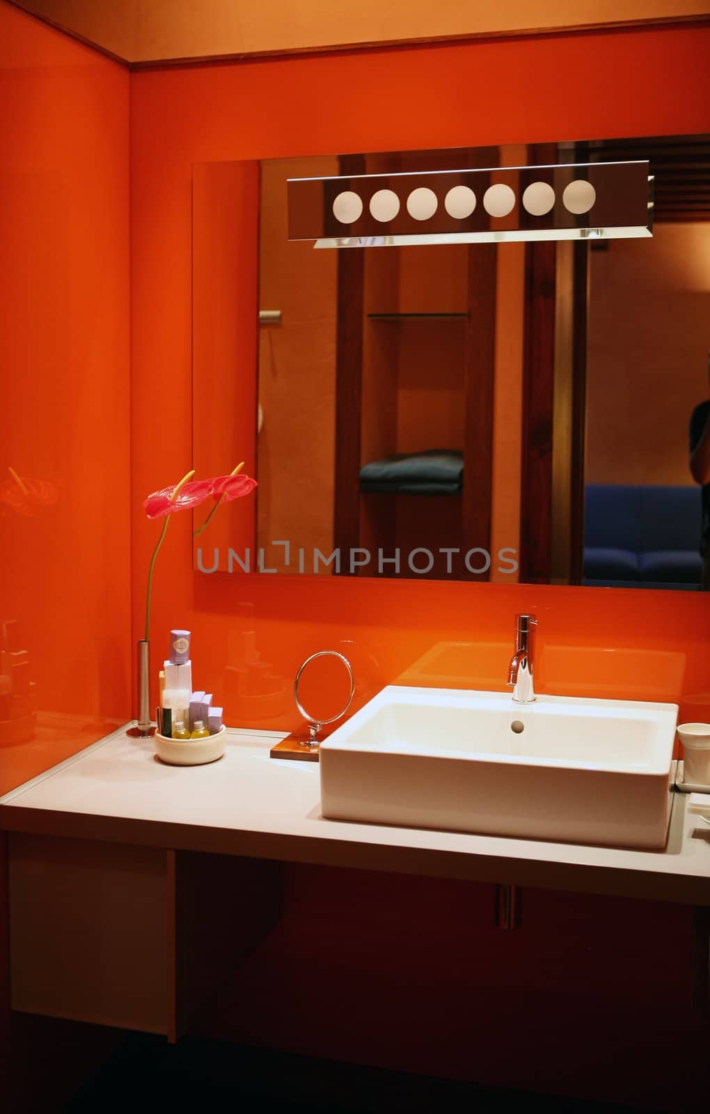 Mirror reflecting red design bathroom in hotel