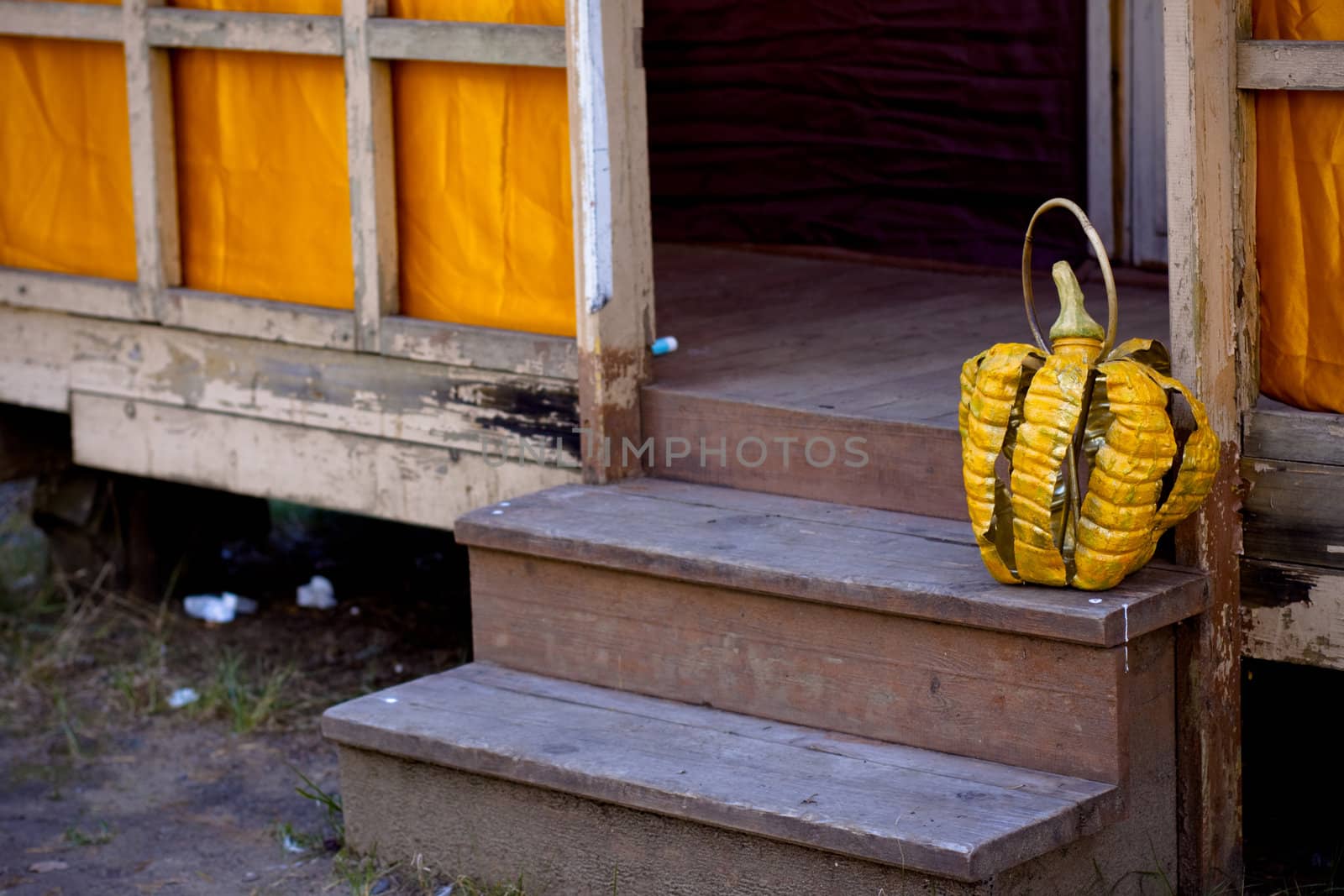 A helloween artificial pumpkin on wooden steps
