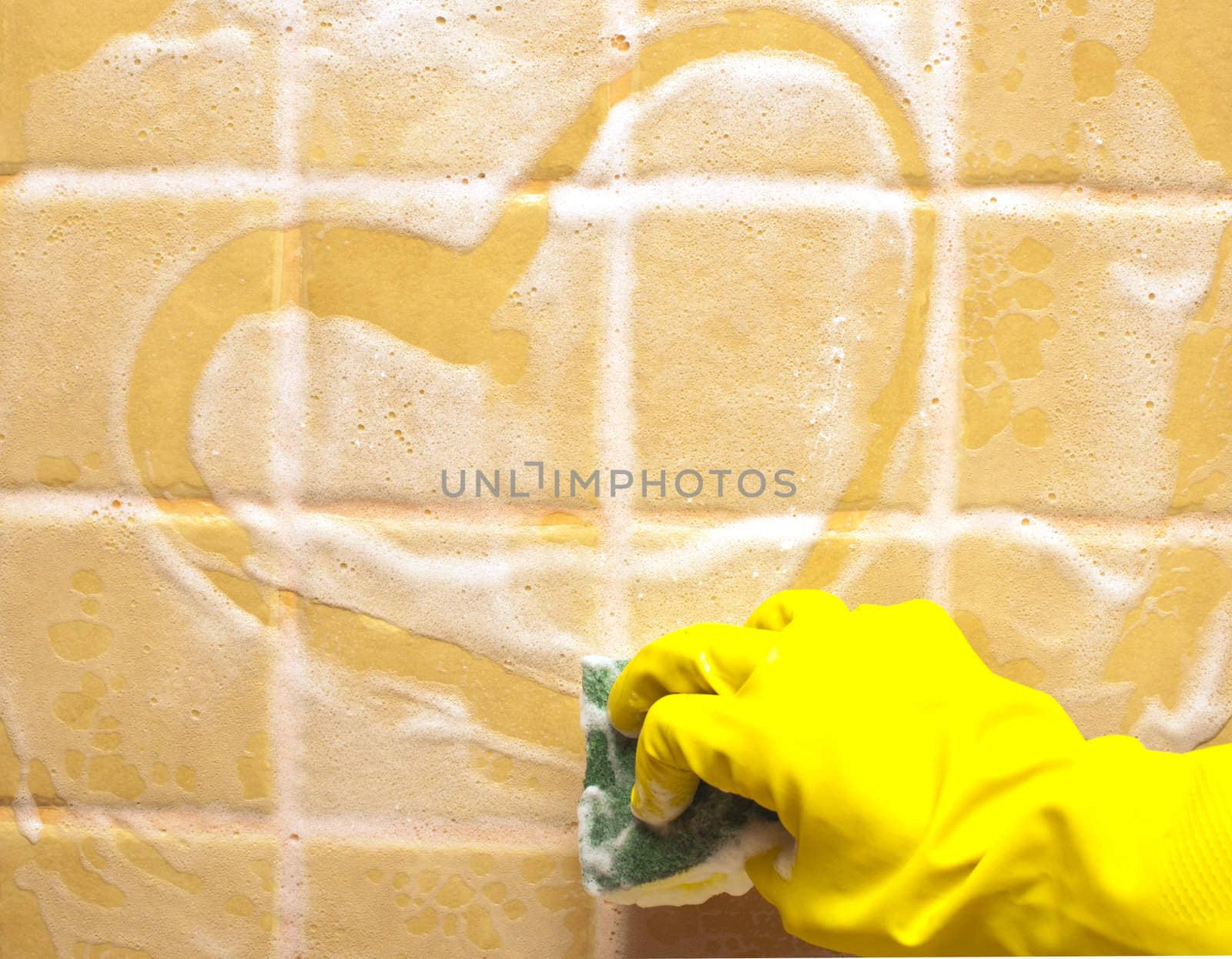 hand in yellow rubber glove draws heart
