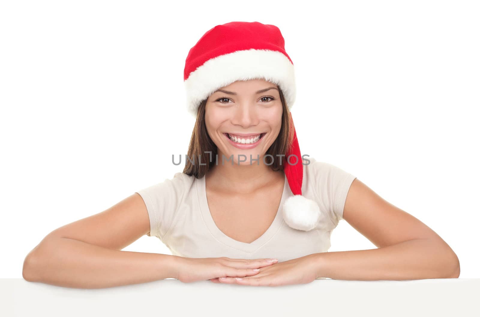 Christmas woman smiling showing blank empty billboard signboard. Asian / Caucasian young female model in Santa hat isolated on white background.