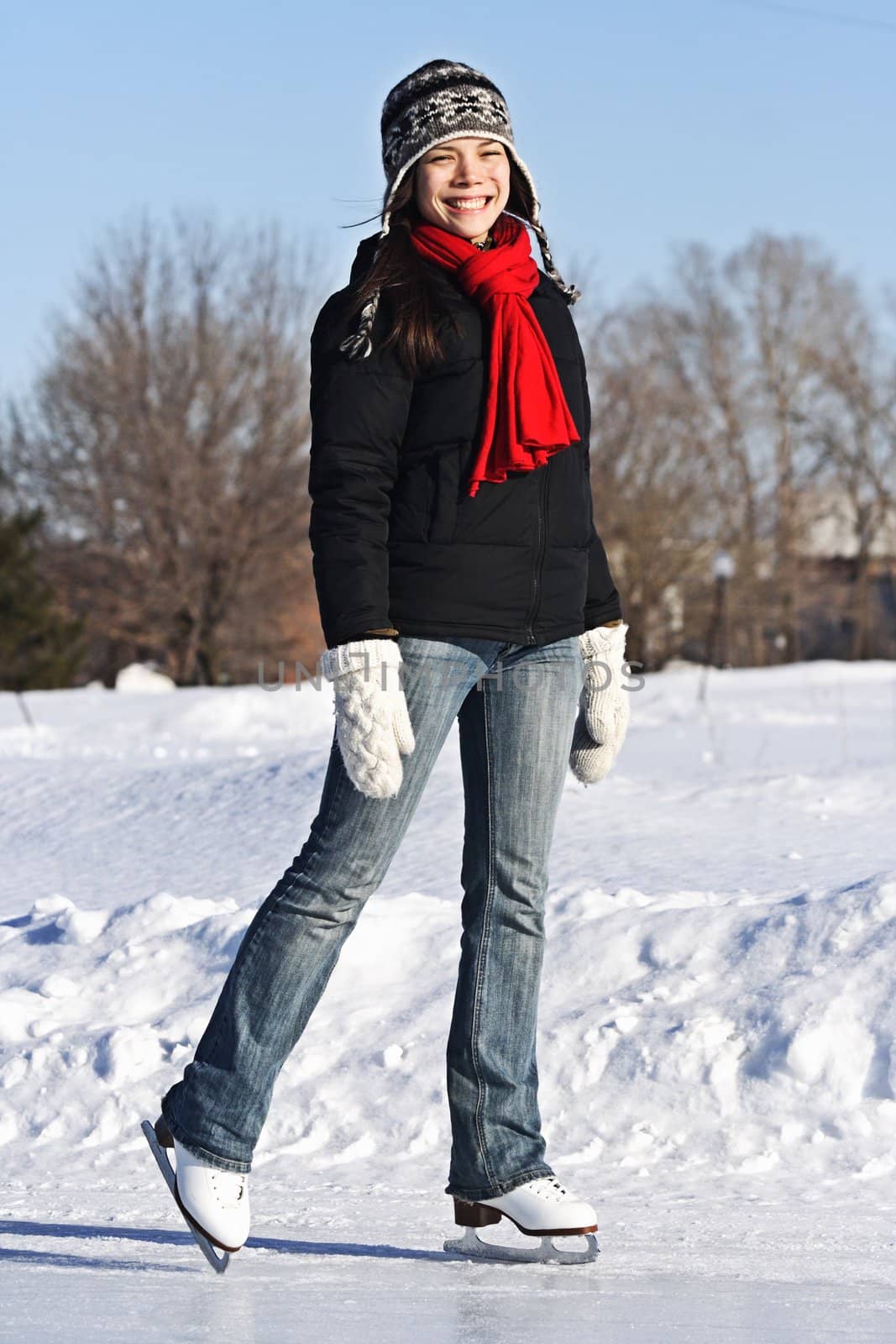 Ice skating girl. Young woman skating on ice with figure skates outdoors in the snow. Quebec,City, Canada.