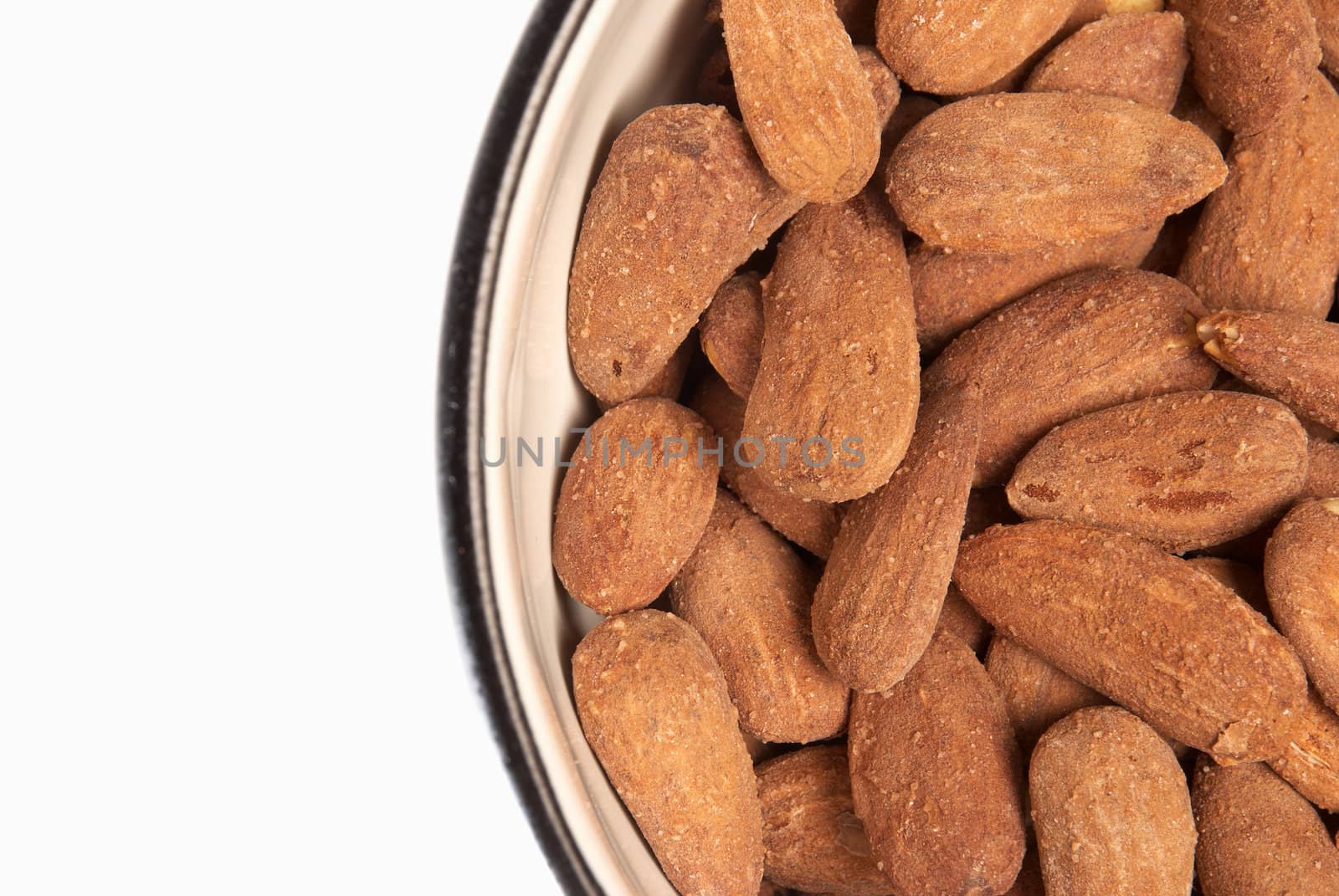 Bowl of freslhy roasted almonds with copy space