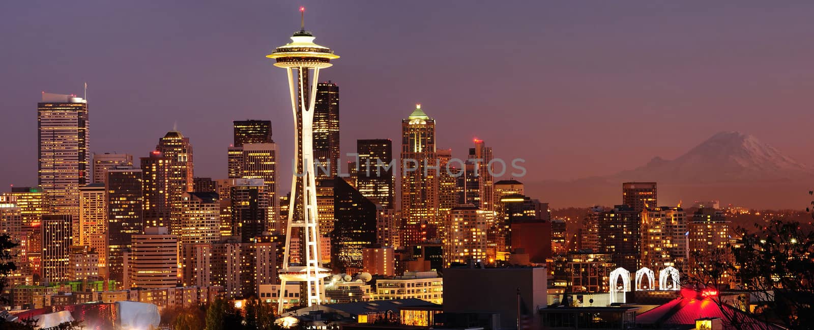 Striking panoramic image of Seattle skyline with Mount Rainier glowing at sunset