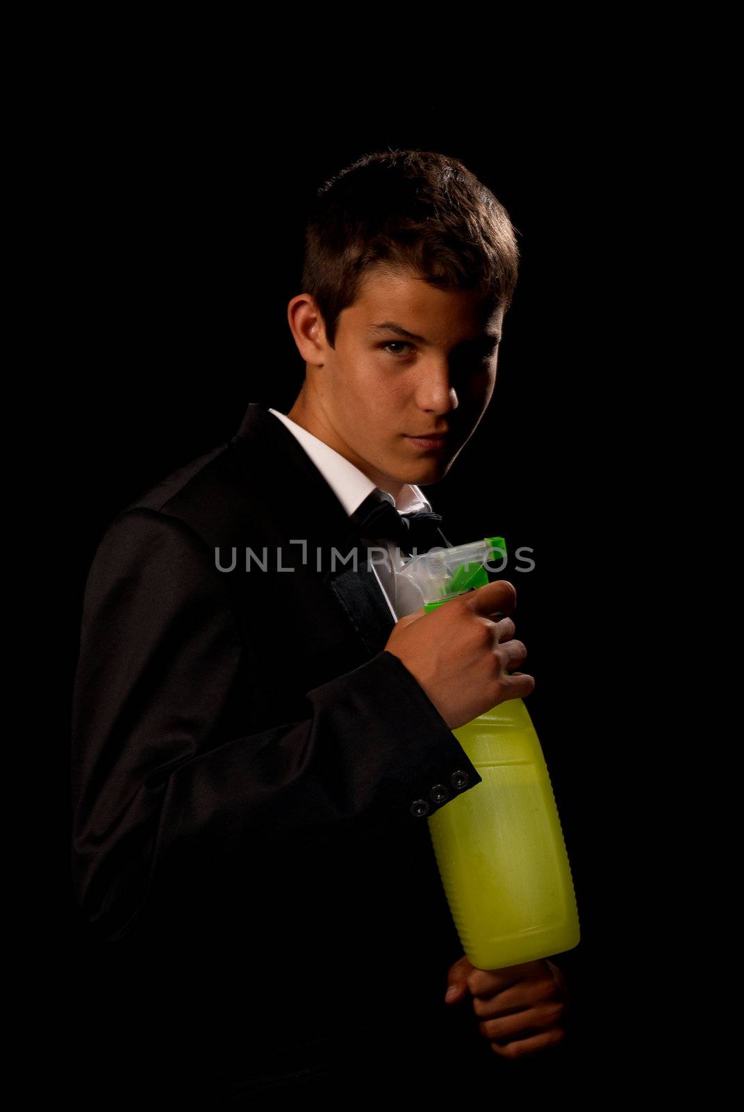 Teenager impersonating 007 holding a cleaning spray