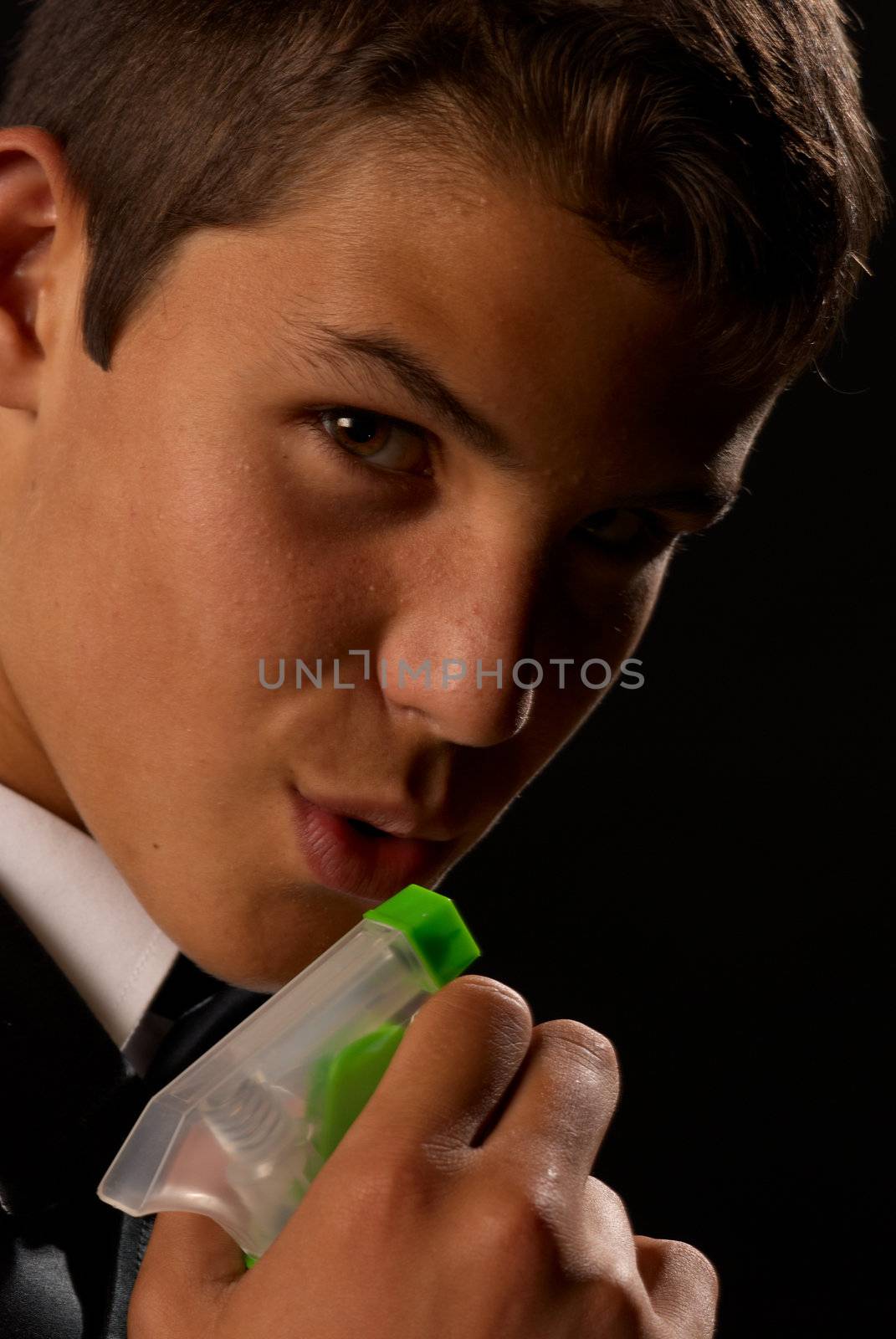 Teen impersonating 007 using a cleaning spray