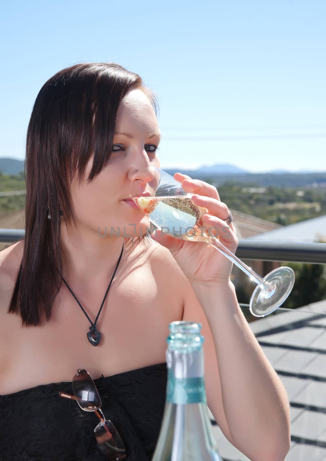 young woman with glass of wine by clearviewstock