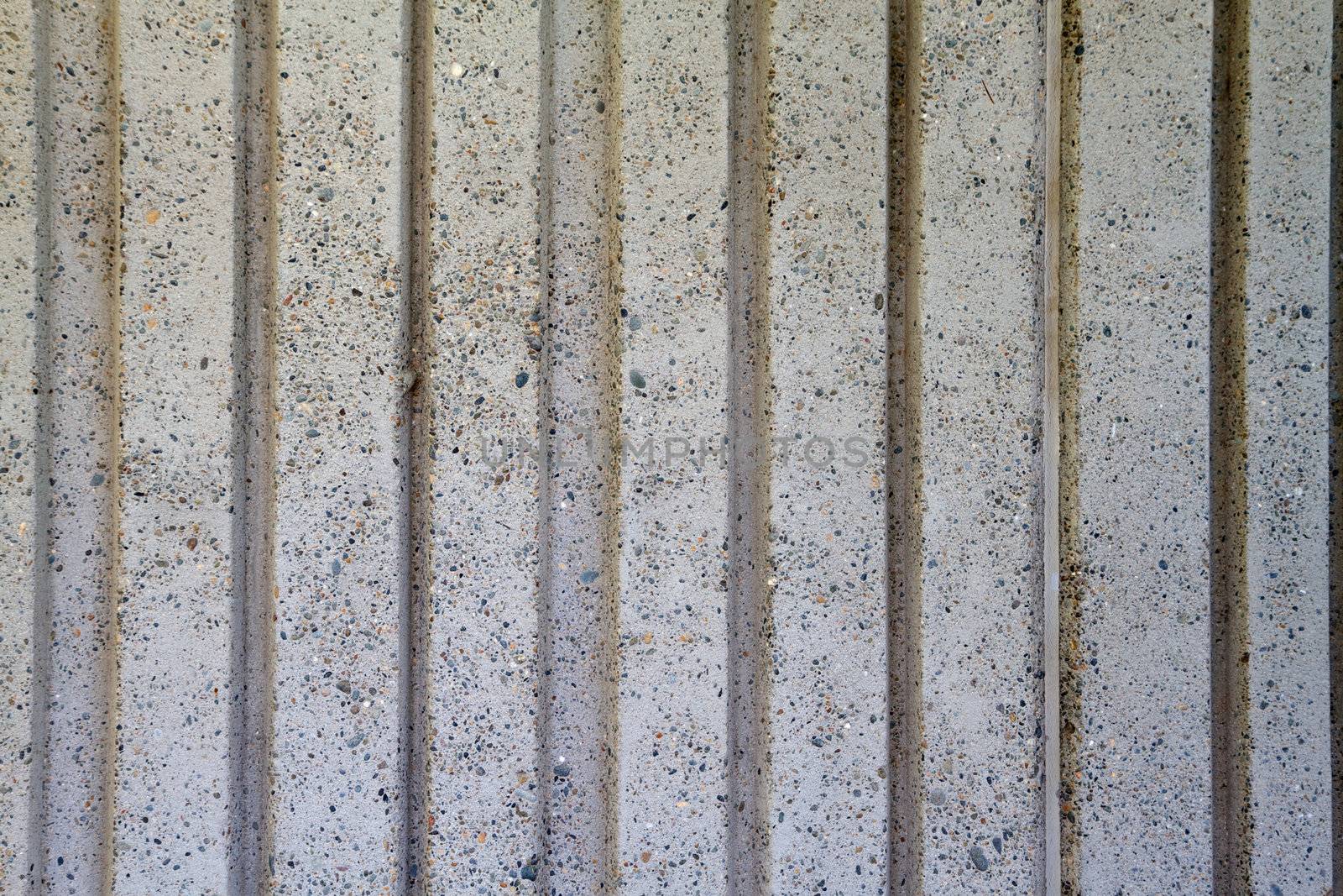 Gray Deep wide vertical grooved concrete wall