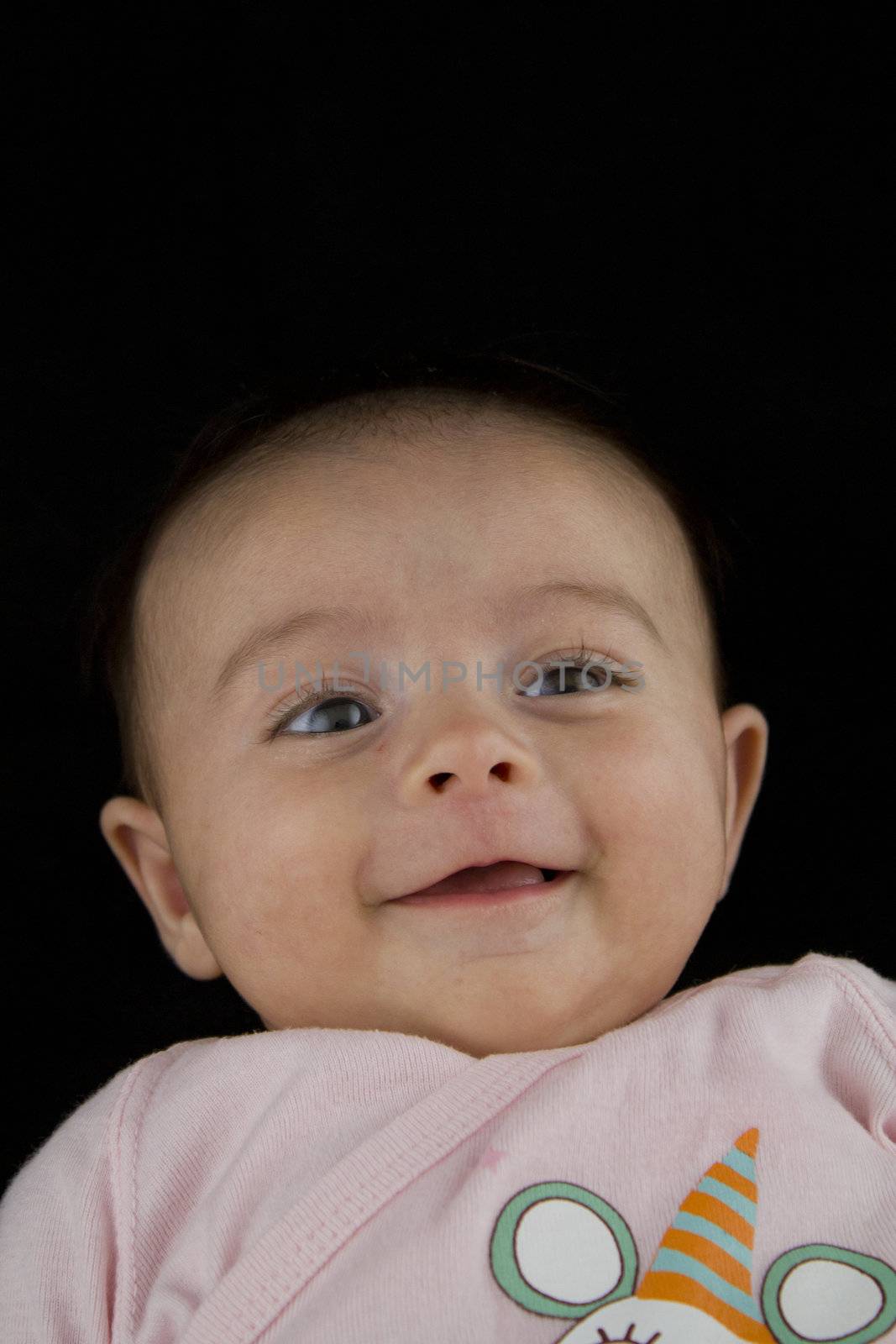 2 Months Old Baby Girl Behavior and Face Expression on a Black Background