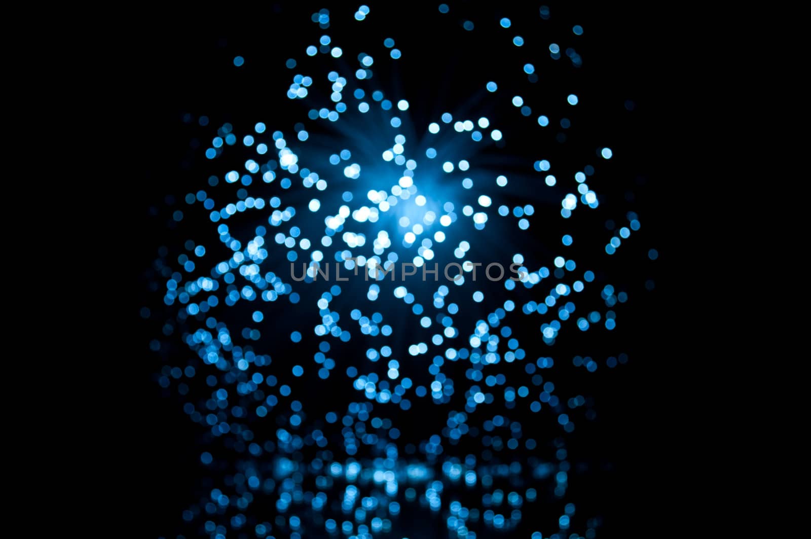 Abstract blur capturing the ends of illuminated fibre optic light strands.