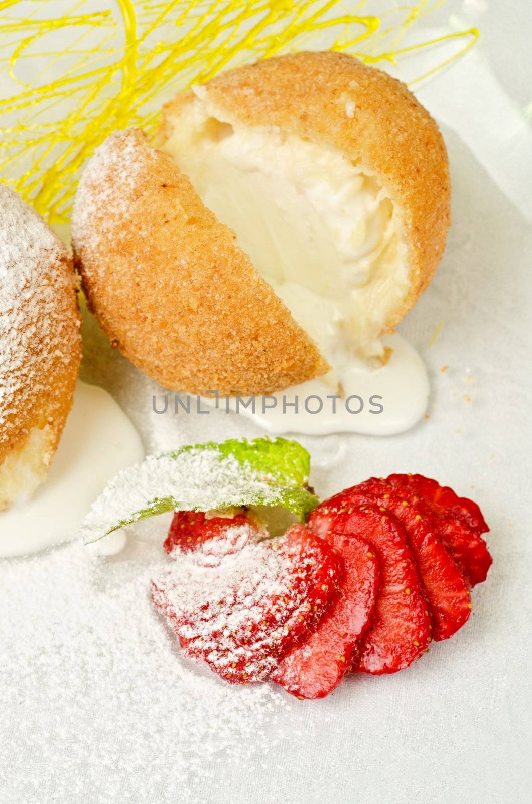 Dessert of ice-cream at biscuit with strawberry and caramel