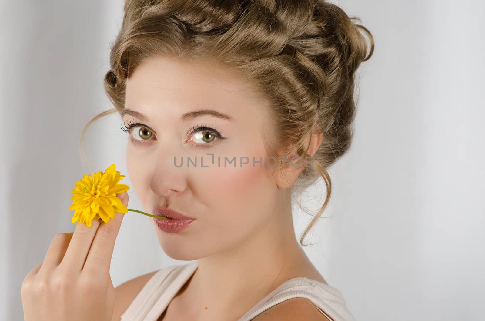 beauty woman closeup portrait with flower over grey background