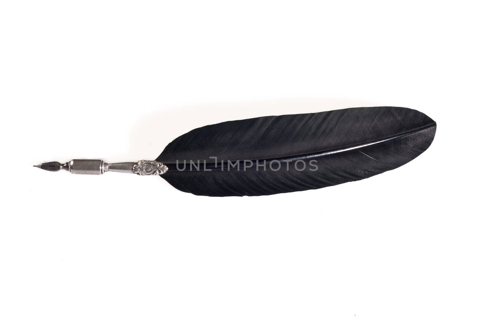 Quill pen made out of silver metal and black feather isolated on white