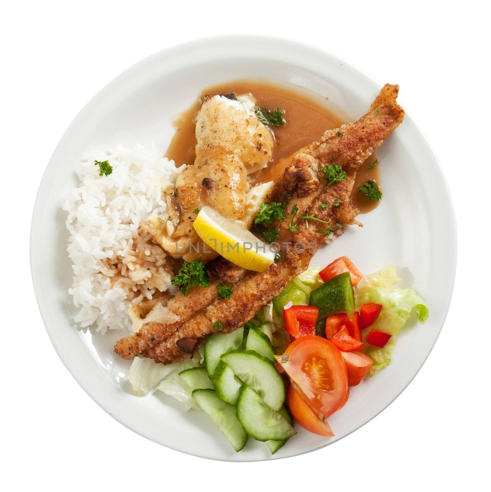 Plate of fried fish fillets with rice and salad isolated on white