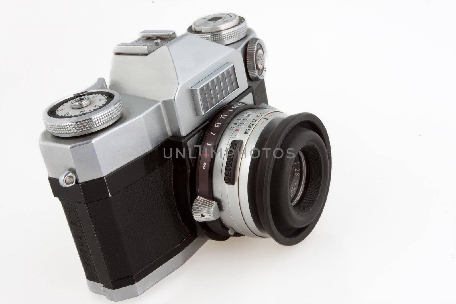 Old vintage SLR film camera isolated on white.