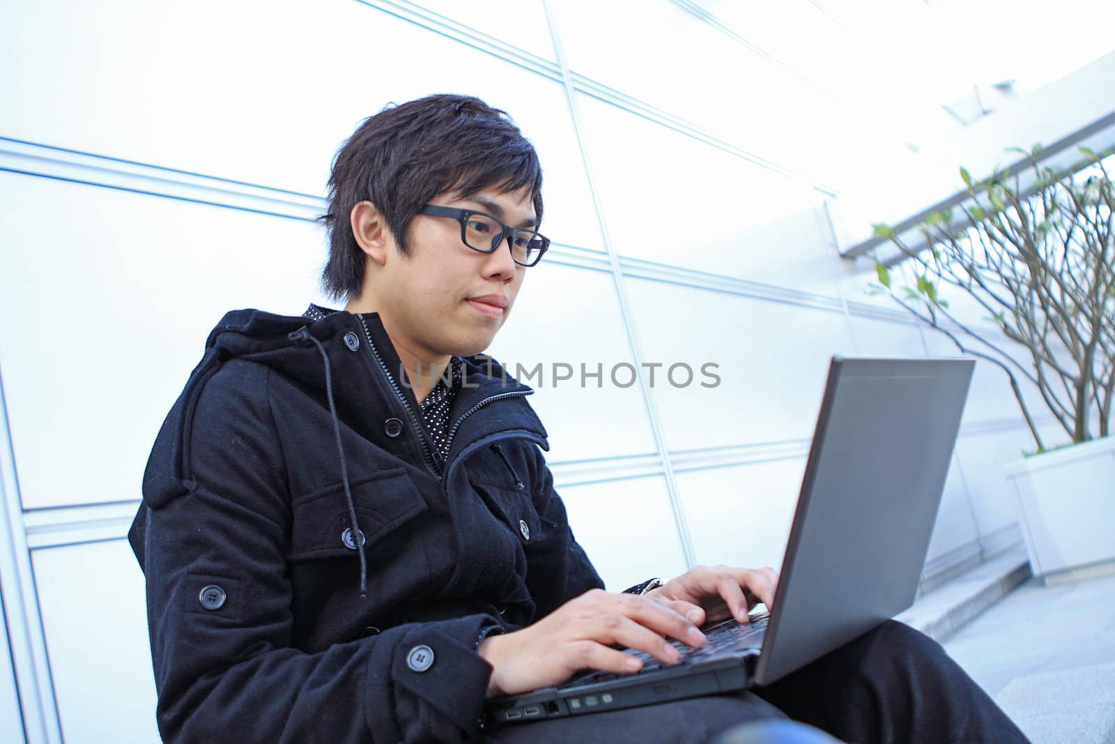 man using computer outdoor  by cozyta