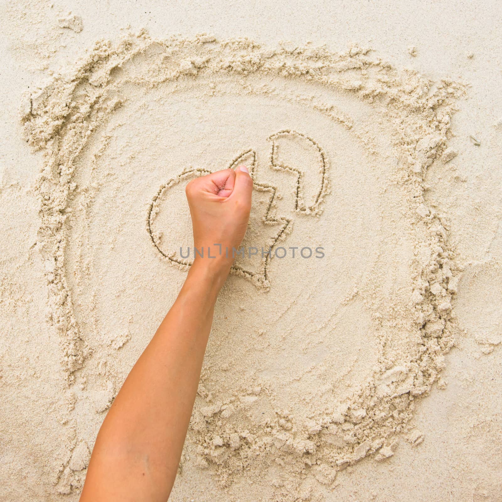 The fist breaking the sand heart