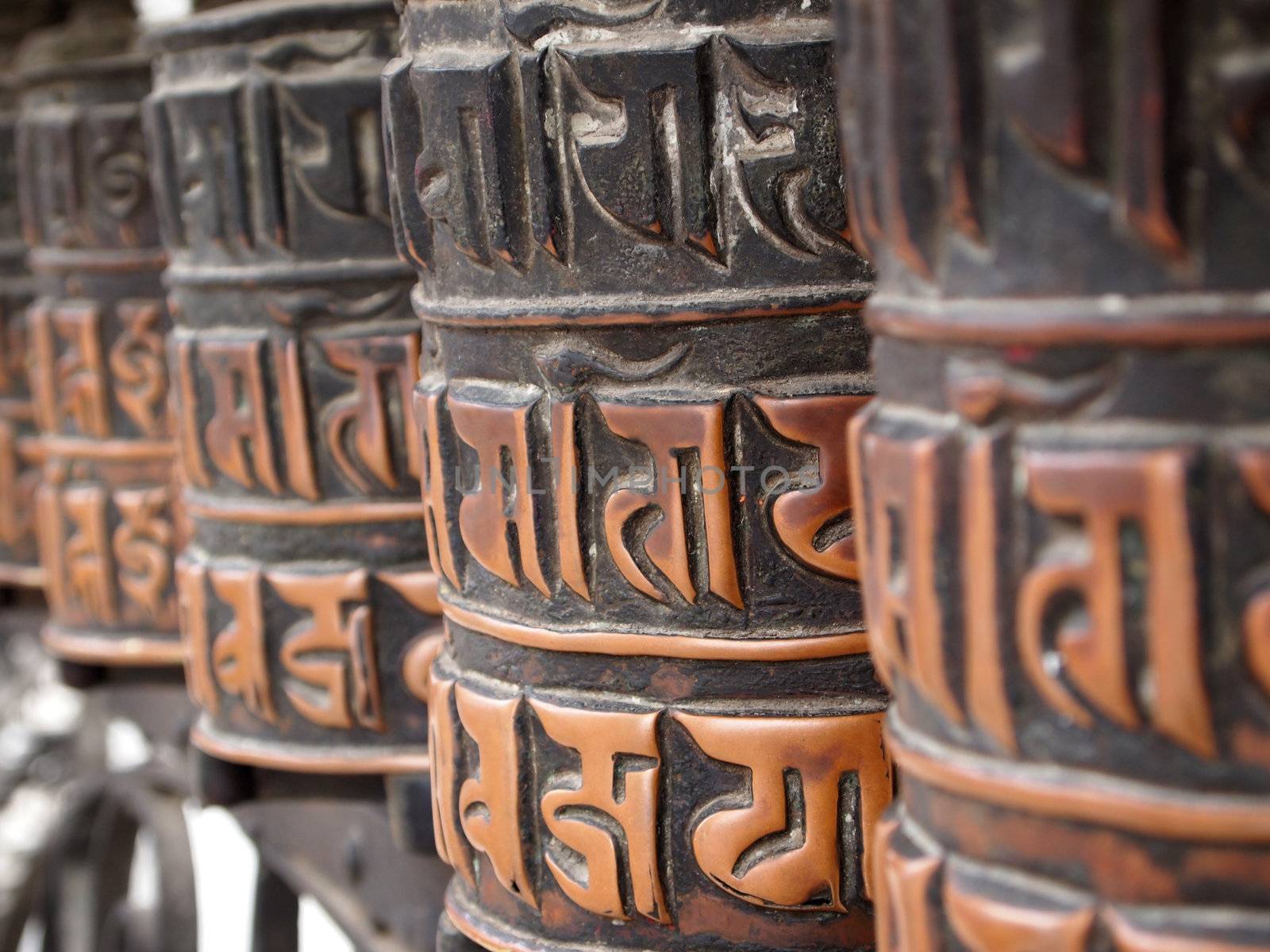 Decorated buddhist prayer wheels in a stupa. 