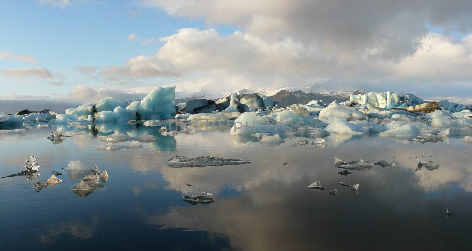 Panorama of Jokulsarlon, glacier lake, in Iceland where icebergs collapsing from Vatnajokull glacier float around.