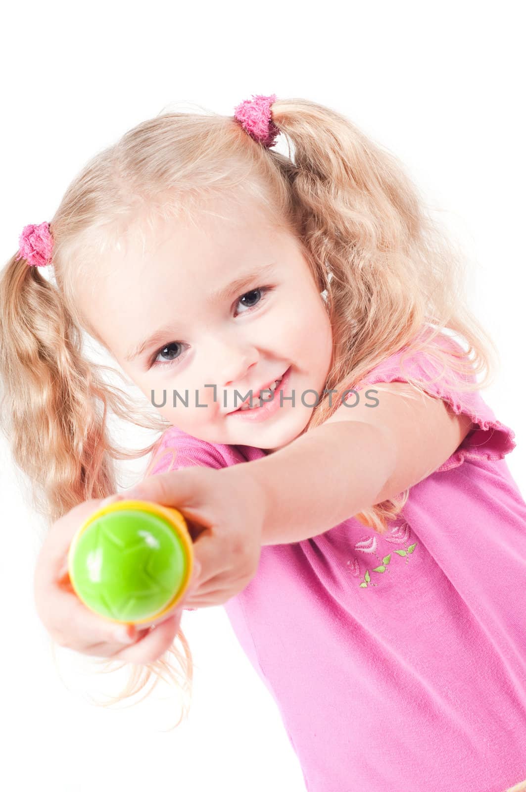 Little cute girl in pink and with ponytails in studio