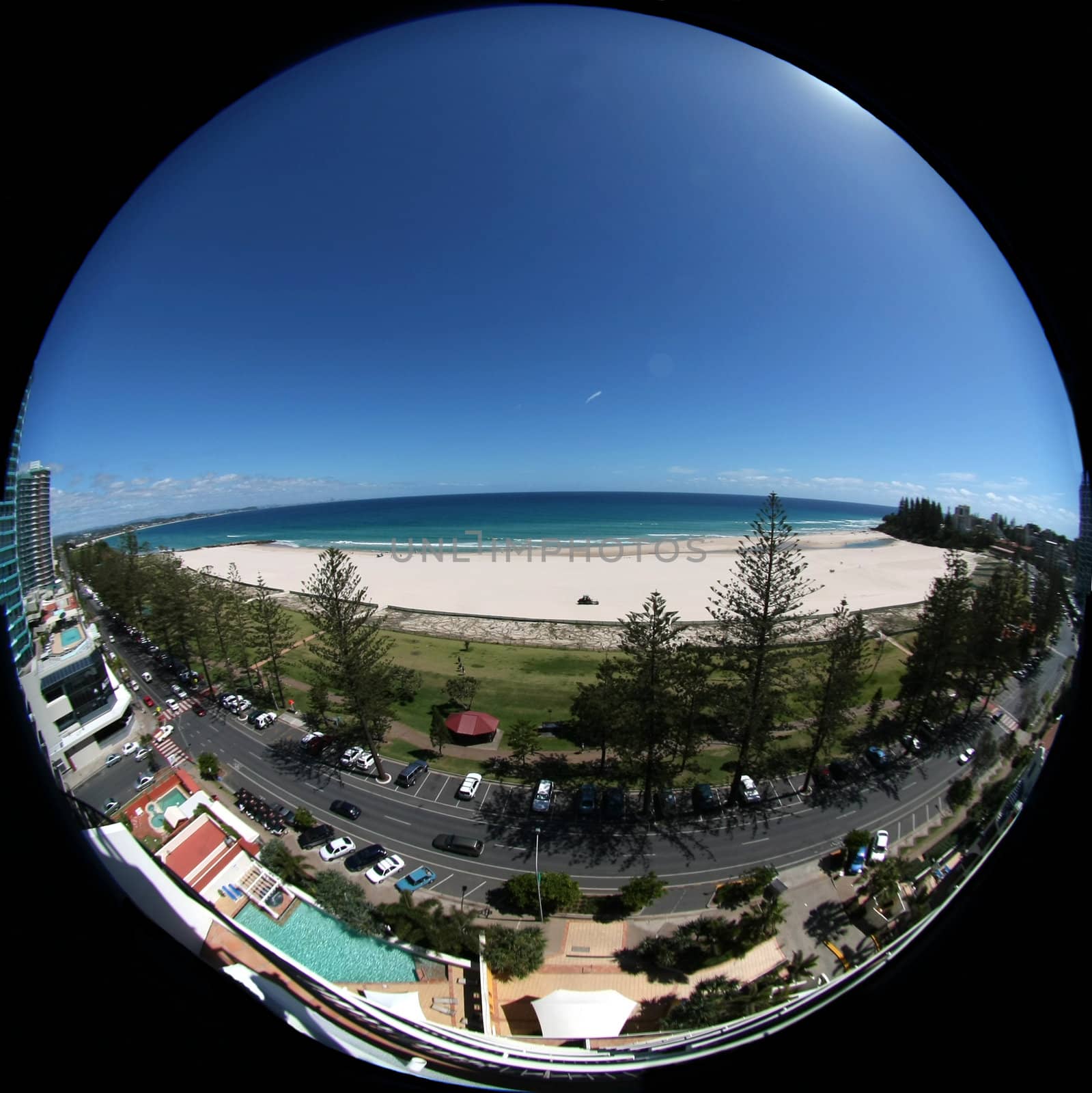 Fish eye view on the beach from a skyscraper balkony by Imagecom