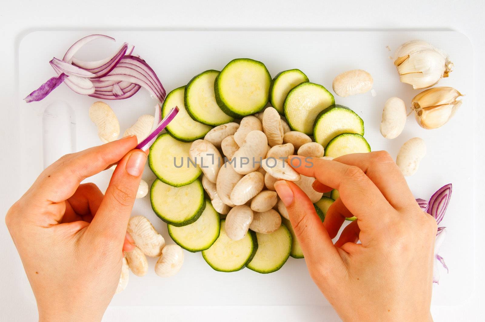 composition of vegetables with your hands on white trays by peus