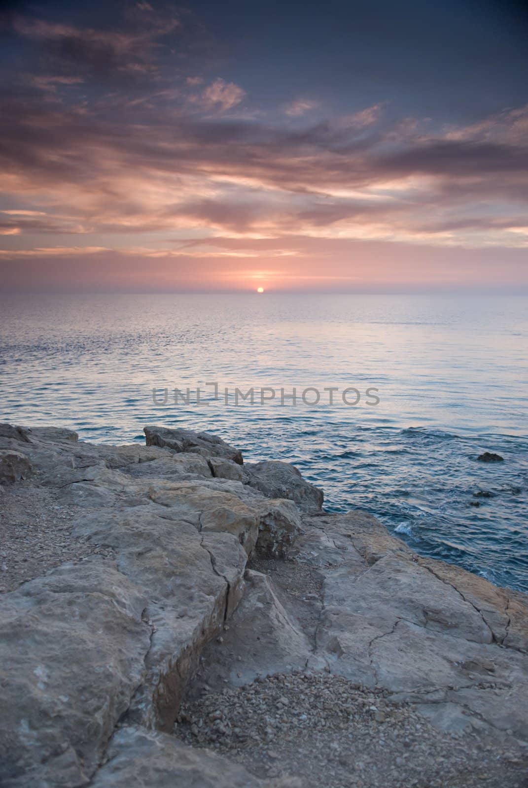 Sunrise and Dramatic sky over a clam ocean,