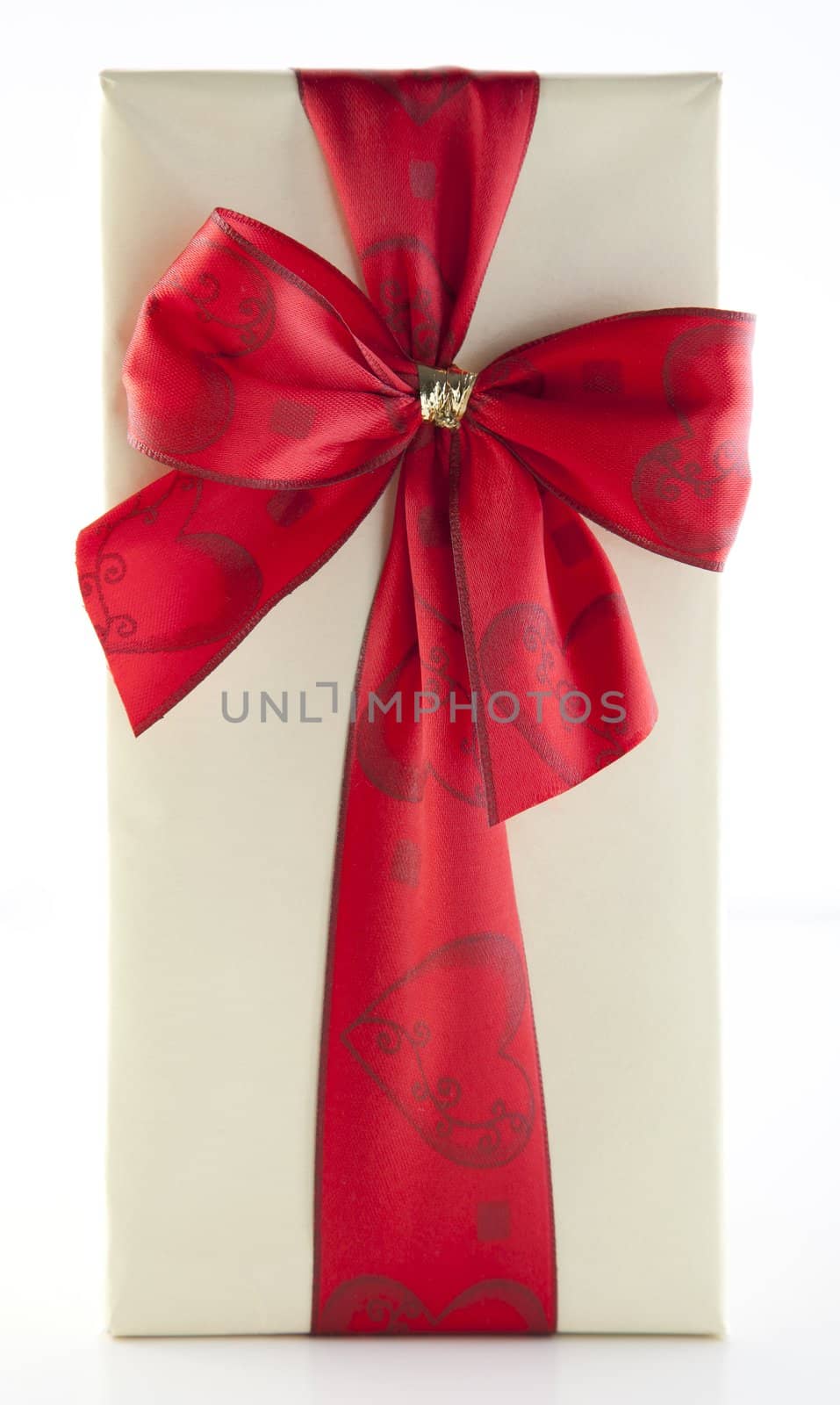 Wrapped gift tied with red ribbon isolated on white background.