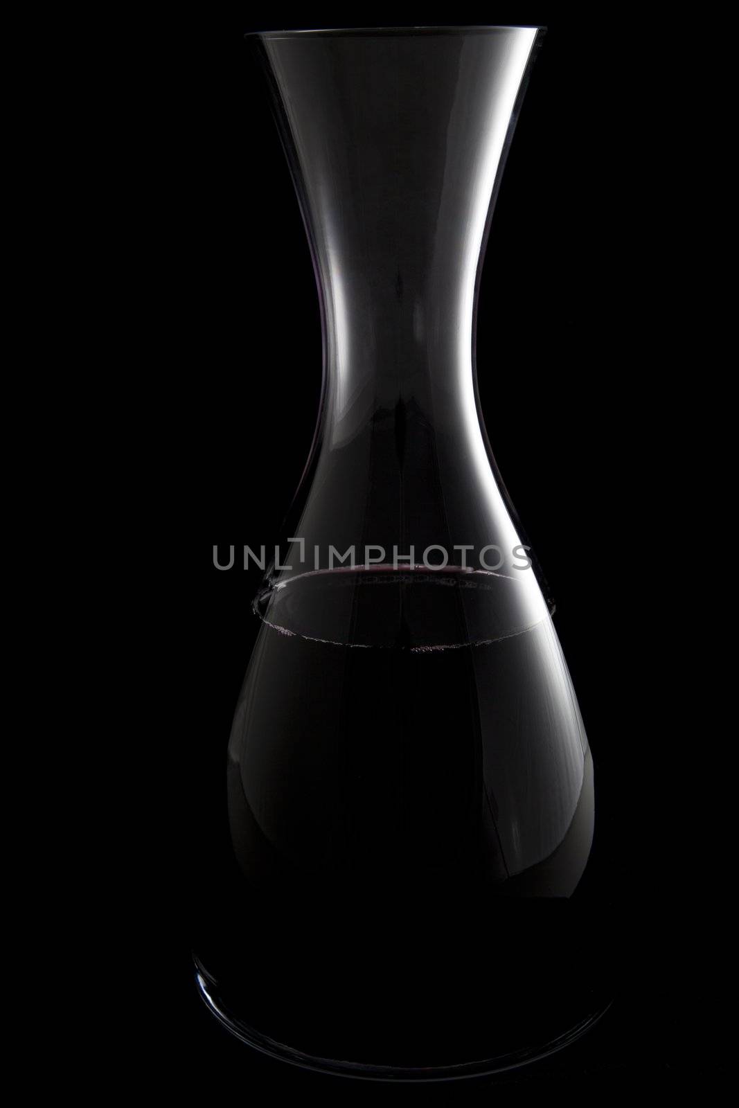 Outlines of wine carafe and  with red wine on black background.