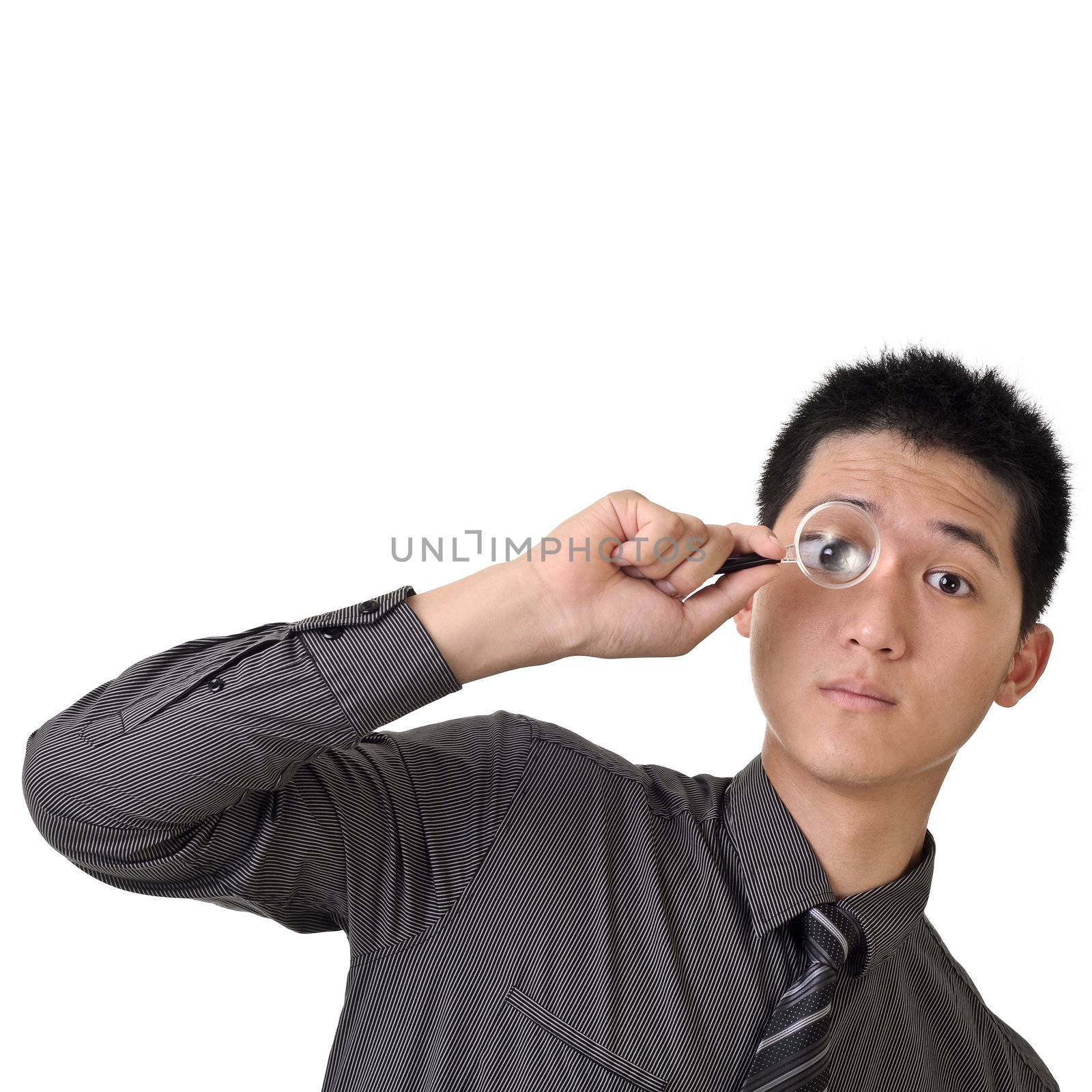 Business man discover concept by holding magnifier on one eye.