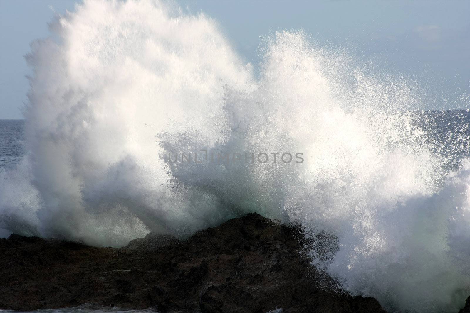 Big waves are breaking on the rock