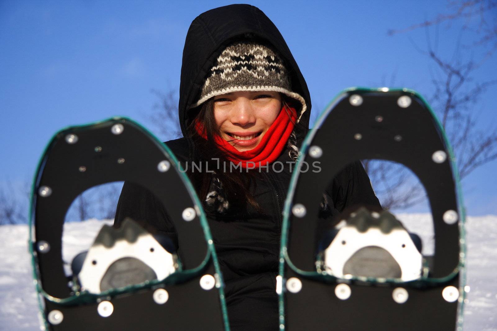 Young woman taking a hiking break with Snow shoes / Rackets in Quebec, Canada