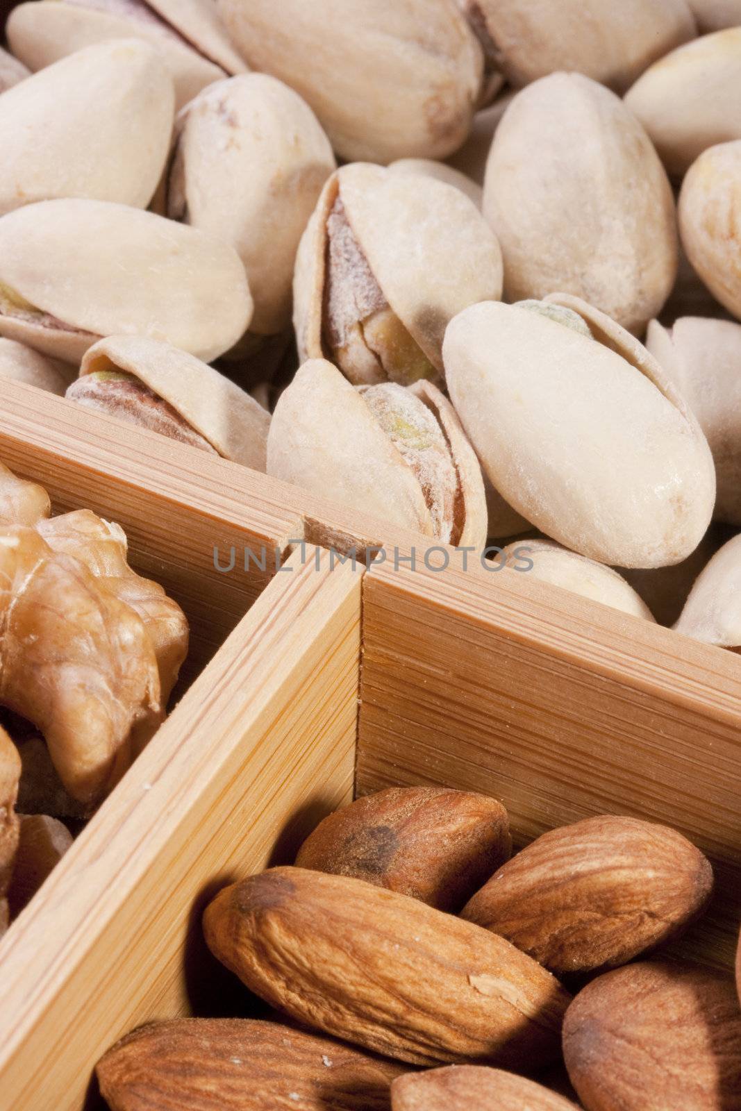 Nuts Almond in a wooden box together with nuts of other grades.